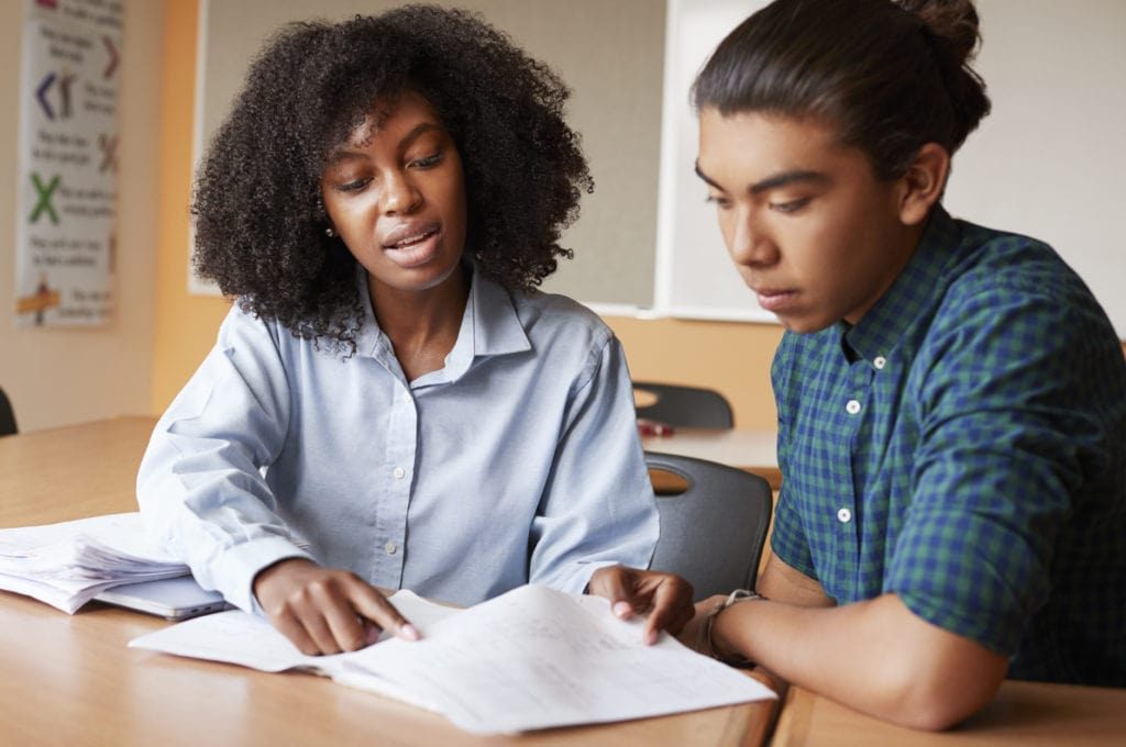 high-school-tutor-giving-male-student-one-to-one-S6AZMV5-1024x680 Two students learning together